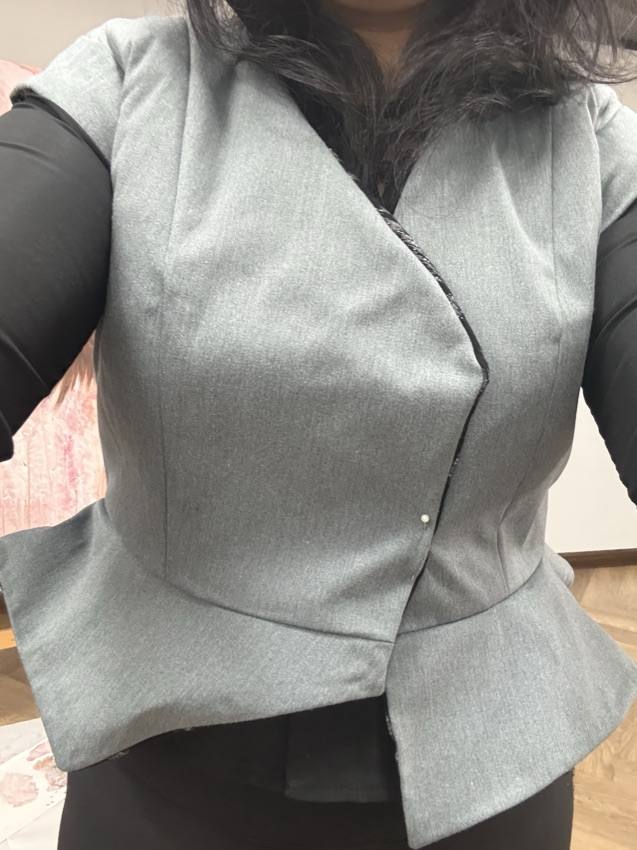Grey peplum vest, worn