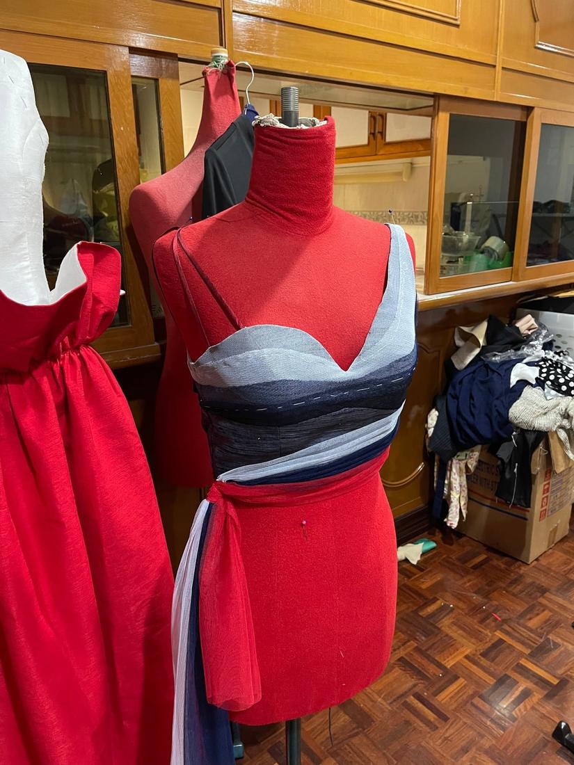 Red silk dress and draped bodice on dress forms
