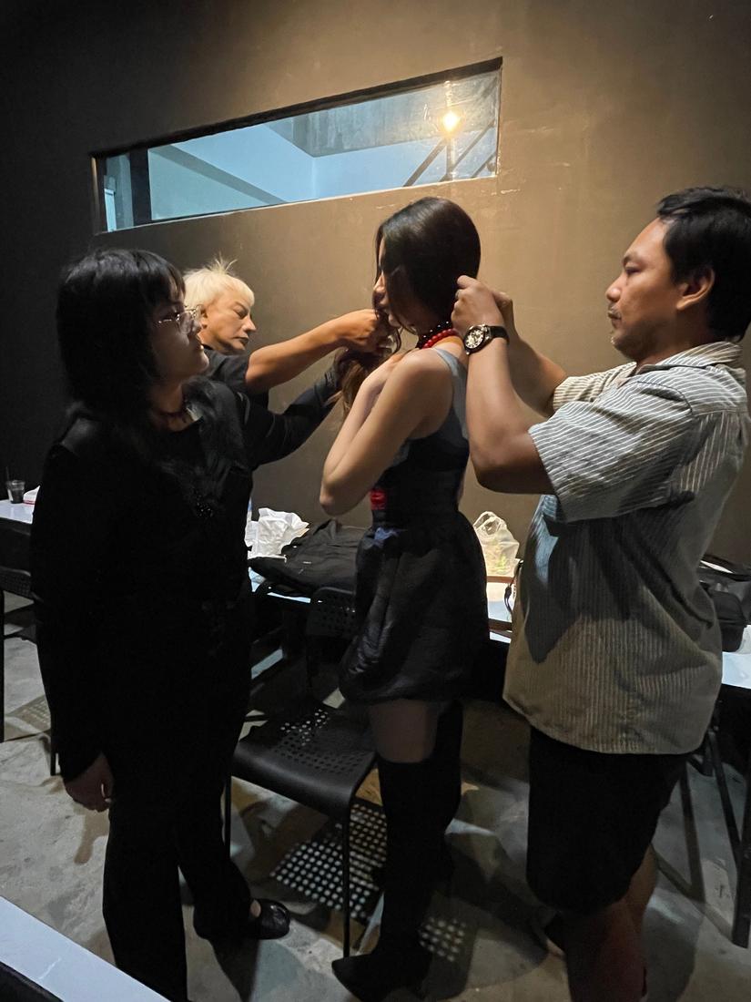 Hair and styling being finished on a model before the shoot