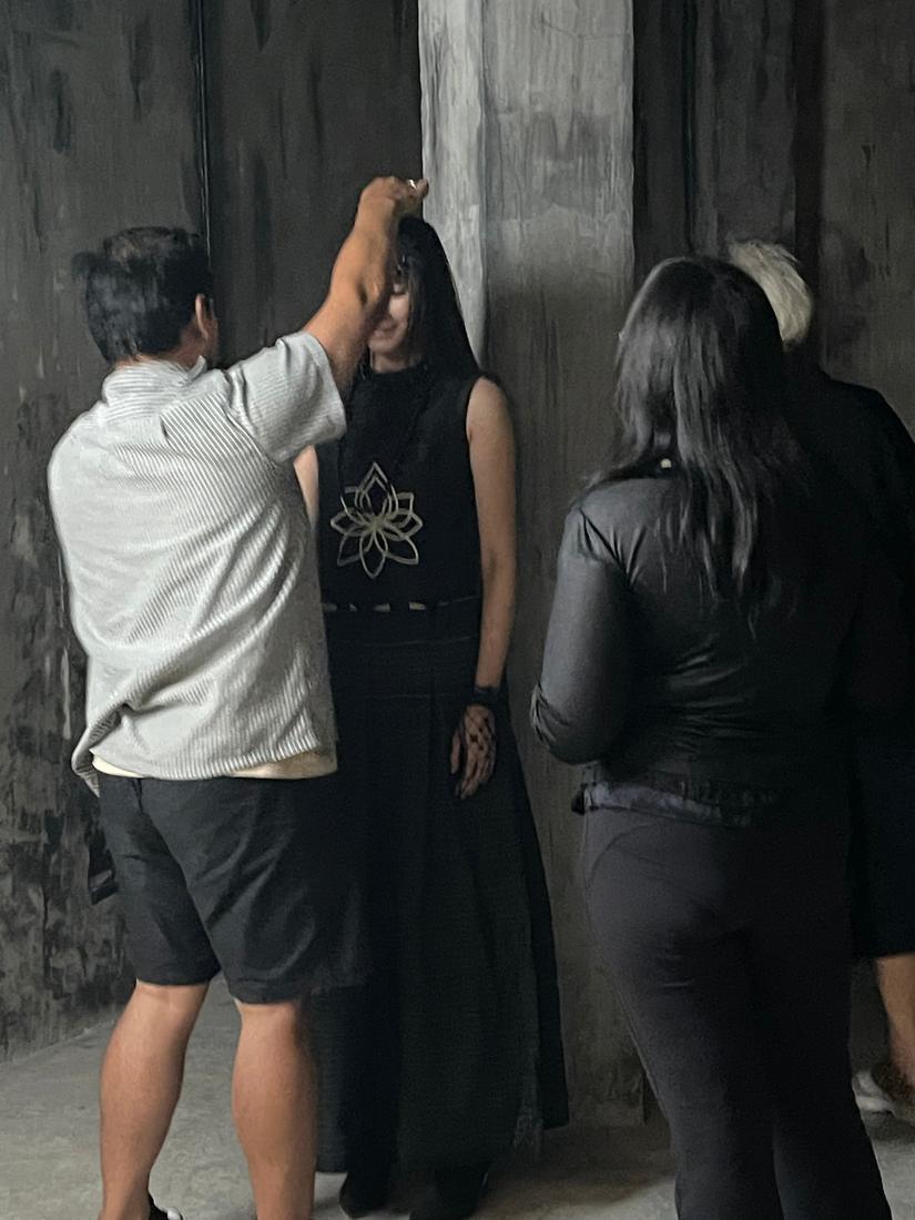 A stylist adjusting a model's look between shots