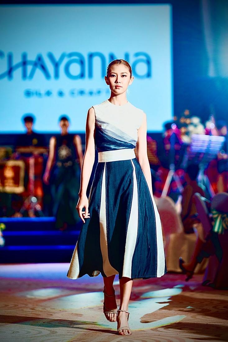 Model on the runway in a navy, white and grey panelled skirt